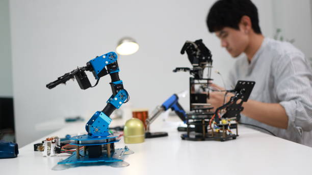 istock The young male mechatronics engineer is examining and analyzing a robotic arm for a new project. 1710638645