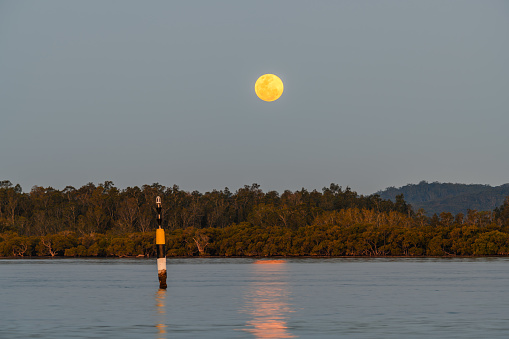 Sunset with a Super Full Moon at Woy Woy Waterfront on the Central Coast, NSW, Australia.
