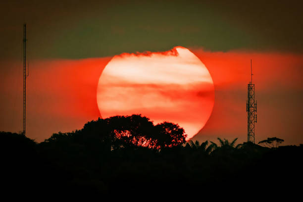 istock Huge sun at sunset urban silhouette with antennas 1710638978