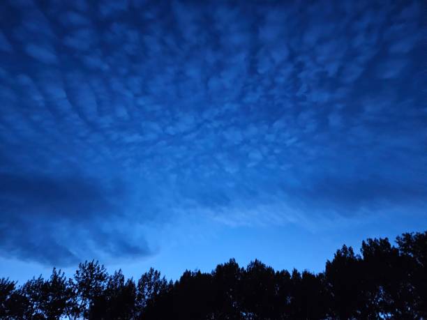 istock Altocumulus clouds at dusk backlit by a vibrant deep blue sky 1710643893