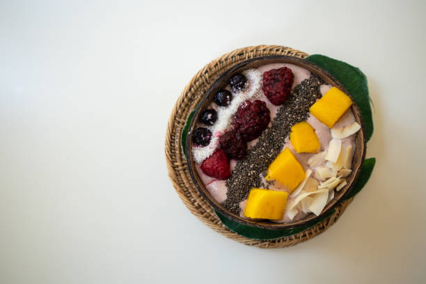 Acai bowl with fresh fruit, healthy food on white background.