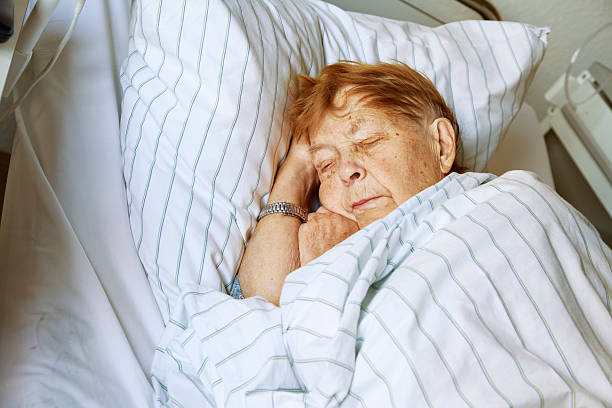 istock senior woman in hospital sleeping 171070127