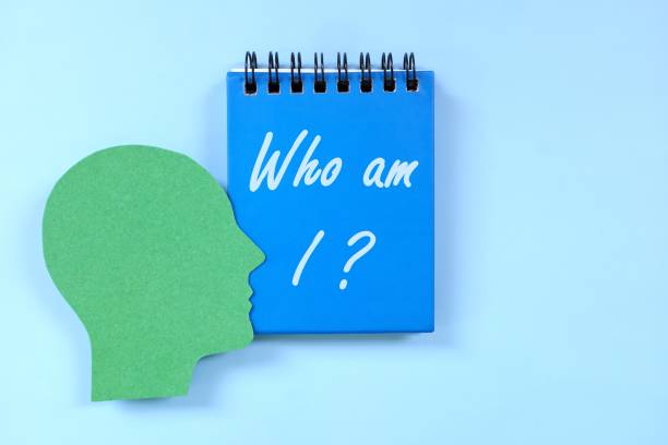 istock Who am I question in blue notebook. Self awareness and knowledge concept. 1710748204