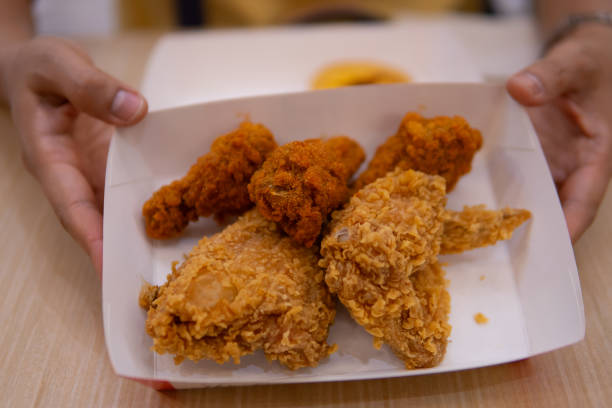 istock Close up women hand holding fried chicken 1710799872