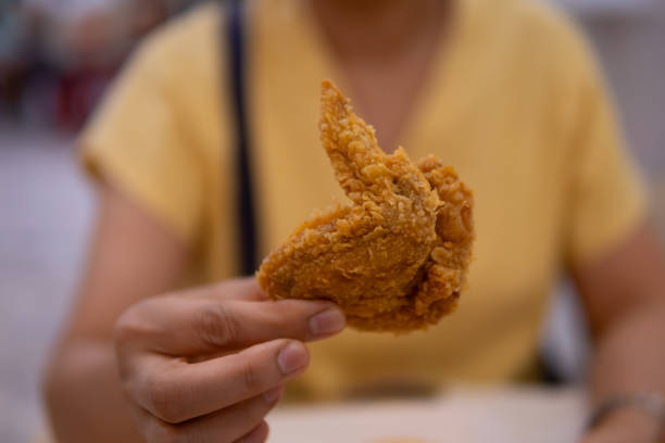 istock Close up women hand holding fried chicken 1710799873