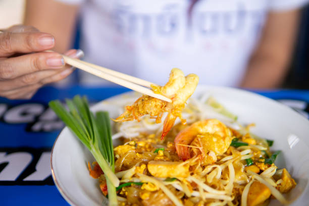 Close up women eating Pad Thai