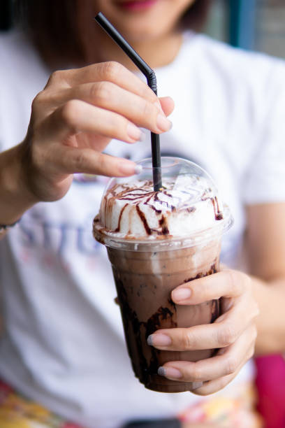 istock Close up women hand holding ice coffee 1710802696