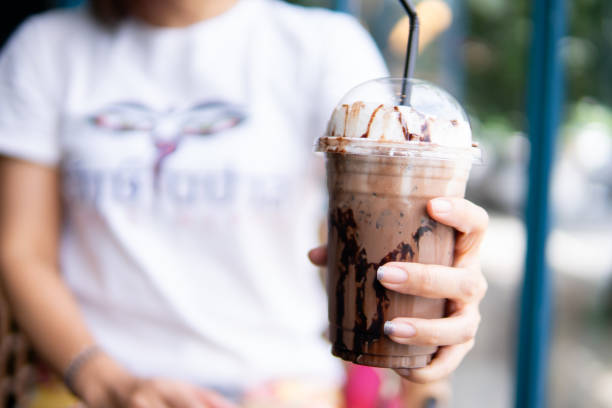 istock Close up women hand holding ice coffee 1710802703