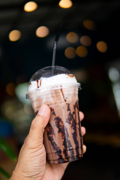 istock Close up women hand holding ice coffee 1710802709