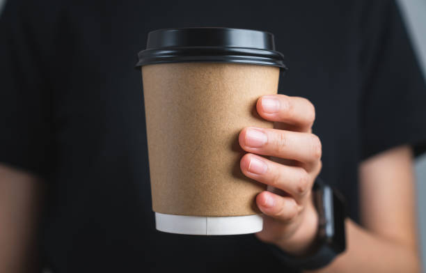 istock Hand holding blank kraft paper coffee cup for takeaway, delivery concept. 1710814404