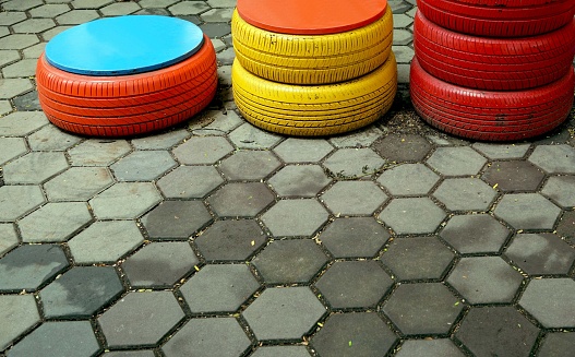 A lot of a pile colorful tire on the ground in the park, children to playing concept.