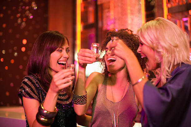 kuvapankkikuvat ja rojaltivapaat kuvat aiheesta friends toasting shot glasses in nightclub - shot glass