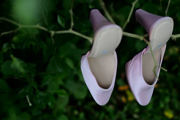 istock close-up view of the bride's white high heels on twig branches 1710850320