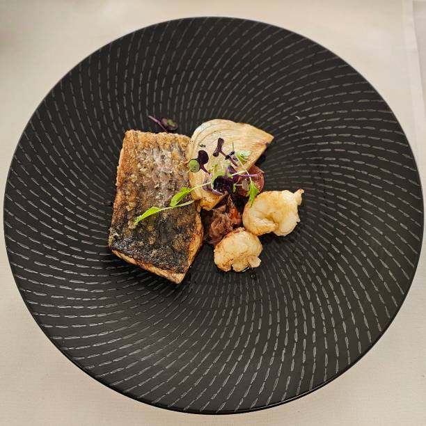 istock Barramundi filet with poached bug tail and fennel 1710856338