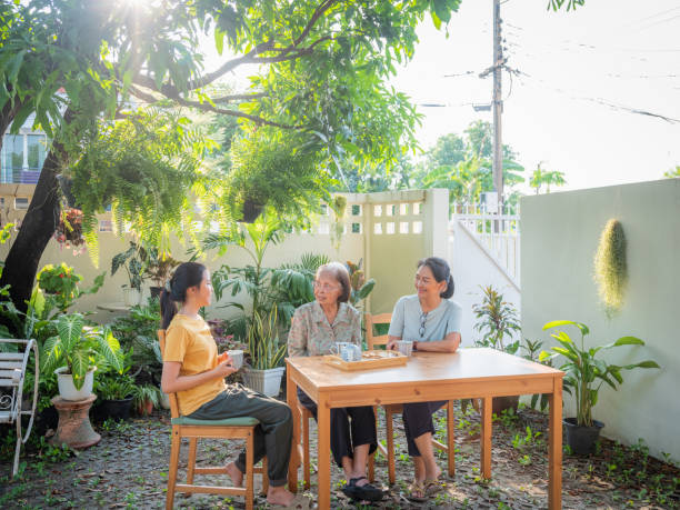 istock Asian multi generation family women enjoy talking and drinking afternoon tea while setting in the backyard at home 1710879515