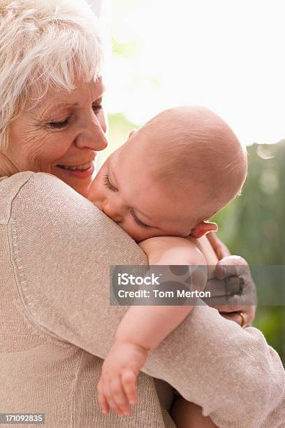 Foto de Avó Segurando O Bebê e mais fotos de stock de 6-11 meses - 6-11 meses, 65-69 anos, Abraçar