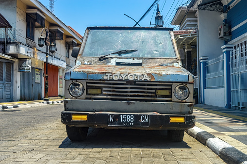 front view of an old Toyota Kijang car parked on the side of the road, Indonesia, 17 September 2023.