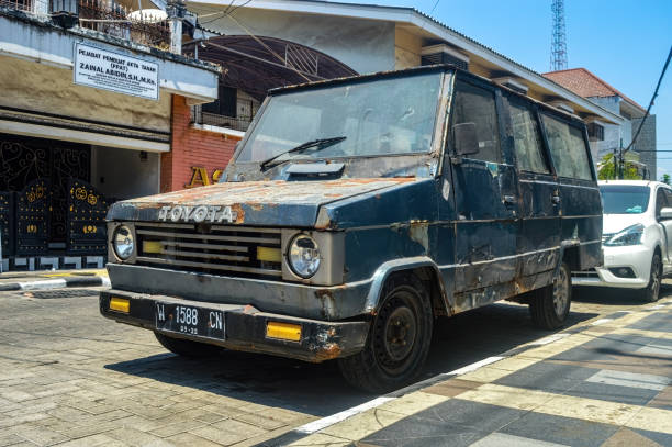 an ancient and dull Toyota Kijang car parked on the side of the old city road an ancient and dull Toyota Kijang car parked on the side of the old city road, Indonesia, 17 September 2023. kijang stock pictures, royalty-free photos & images