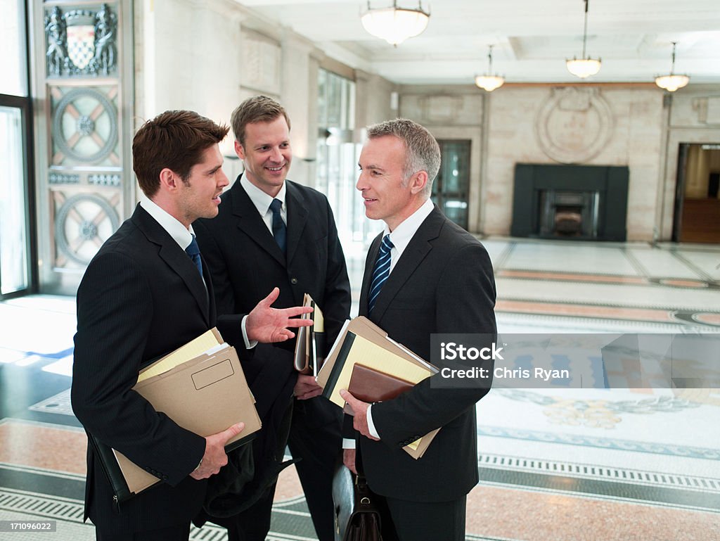 Lawyers with files talking in lobby  Lawyer Stock Photo