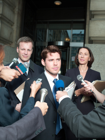 Unrecognizable male public speaker holding a microphone