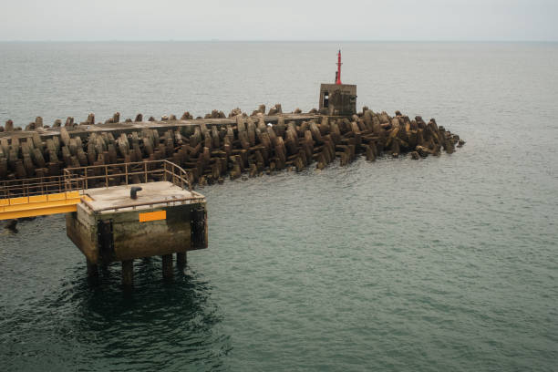 Stretching out into the sea, the lengthy pier on the island's harbor serves as a vital connection between land and water, a bustling hub for maritime activities and tranquil waterside strolls.