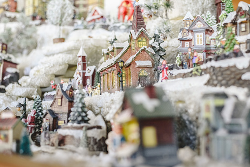 Figures and Christmas decorations in Nordic style, miniature houses with a snowy village.