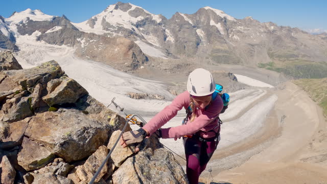 Woman climbing on an Alpine route in summer