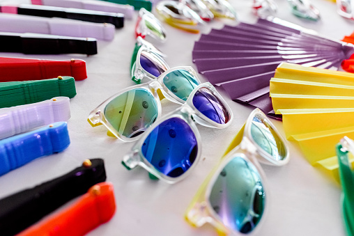 Fun set of fans and sunglasses of many colors for parties in summer.