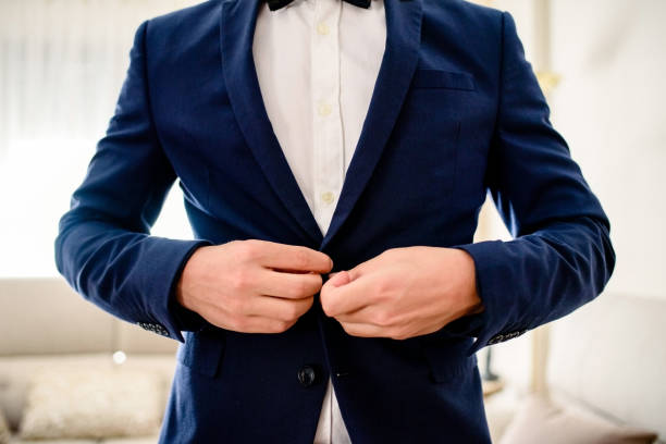 istock Man grooming and dressing in a sober and elegant suit for an event. 1711003221