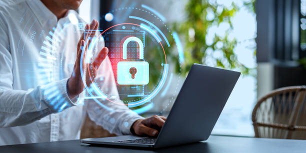 istock Businessman waving to the computer, cybersecurity hologram with lock icon 1711018058