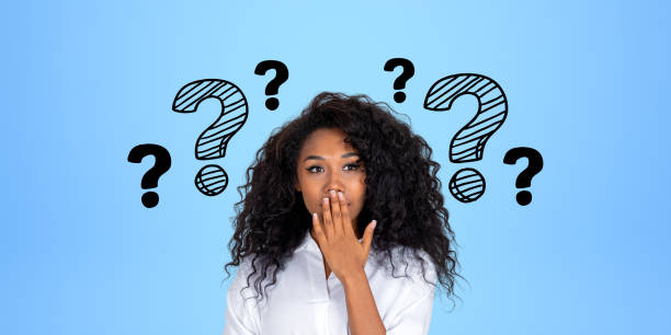 istock African woman with surprised look, covering her mouth, question marks 1711023043