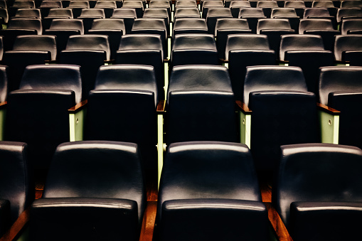 Rows of empty seats and seats in an auditorium.