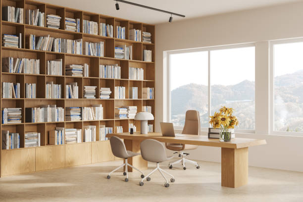 istock Beige consulting interior with laptop on table and bookshelf, window 1711048866