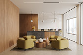 Stylish reception interior with lounge zone and workspace with panoramic window