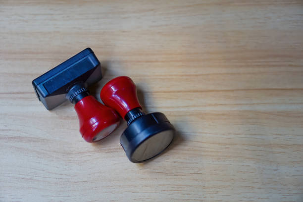 Stamp, Modern stamp, Red Handle Rubber Stamp on wooden table.