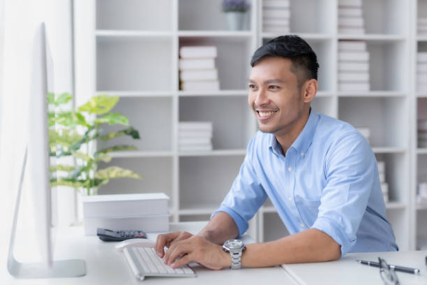 istock Young committed asian businessman sitting working with a laptop computer in the office. 1711051564