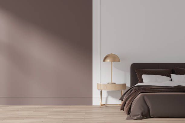 istock Modern hotel bedroom interior with bed and lamp on nightstand. Mockup wall 1711052678