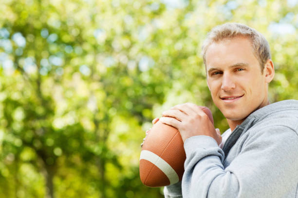 istock Young Man Holding American Football 171106124