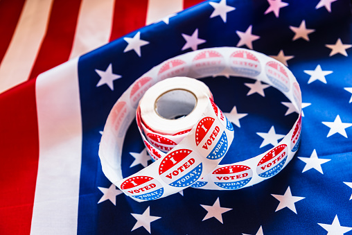 Stickers for voter supporters who have fulfilled their duty to cast their vote in the American elections, background with flag.