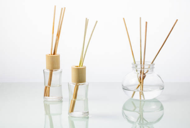 istock Glass bottles with incense sticks on a white mirror table 1711066093