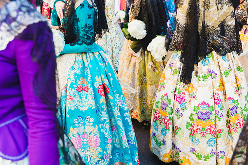 Detail of the traditional Spanish Valencian Fallera dress, colorful fabrics with intricate embroidery.