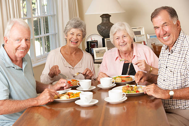 istock Group Of Senior Couples Enjoying Meal Together 171106931
