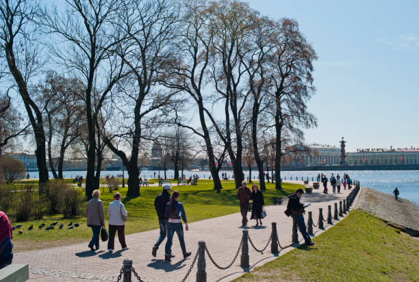 St Petersburg, Russia - May 6, 2012: People are walking in the park near Peter and Paul Cathedral. After visiting cathedral there is long way to the outside. This park is the end of this exit. Couples walking.