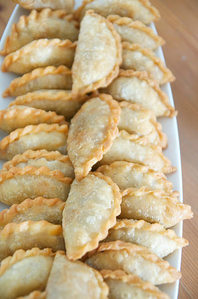Potato curry filled puffs with natural light source from the right. An asian delicacy deep fried puffs that are bite size.