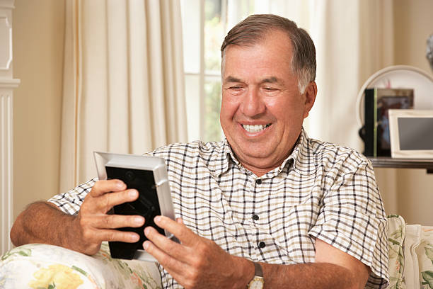 istock Happy Retired Senior Man Sitting On Sofa At Home 171107521