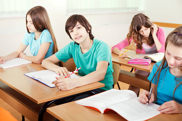 istock Group of cheerful preteen students in class 171107540