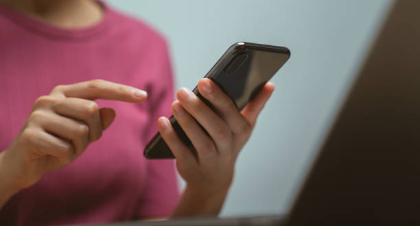 istock Hand holding smartphone with using social media on internet on table. 1711077541