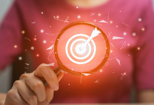 istock Hand holding magnifying glass with show target goal on virtual screen, future growth, planning and success business concept. 1711079165
