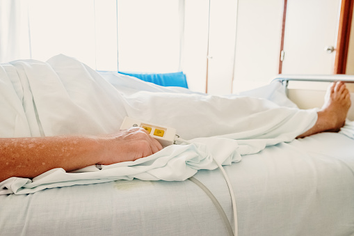 Elderly woman convalescing a bedridden disease.