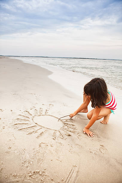 istock drawing sunshine in the sand 171108739